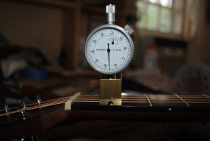 Figure 2. Measuring the string height at the first fret with a custom micrometer. A ruler with 1/64-inch increments (Figure 1) or a feeler gauge will work just as well.