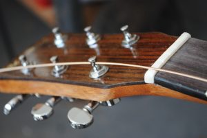 Figure 4. Line the tuner hole so the string will make a straight line from the bridge.